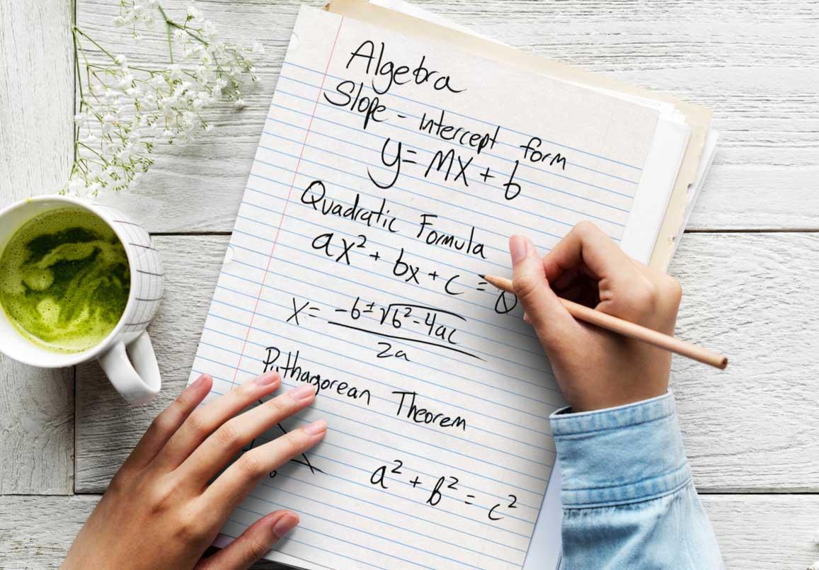 photo of a student working on a problem using the quadratic formula